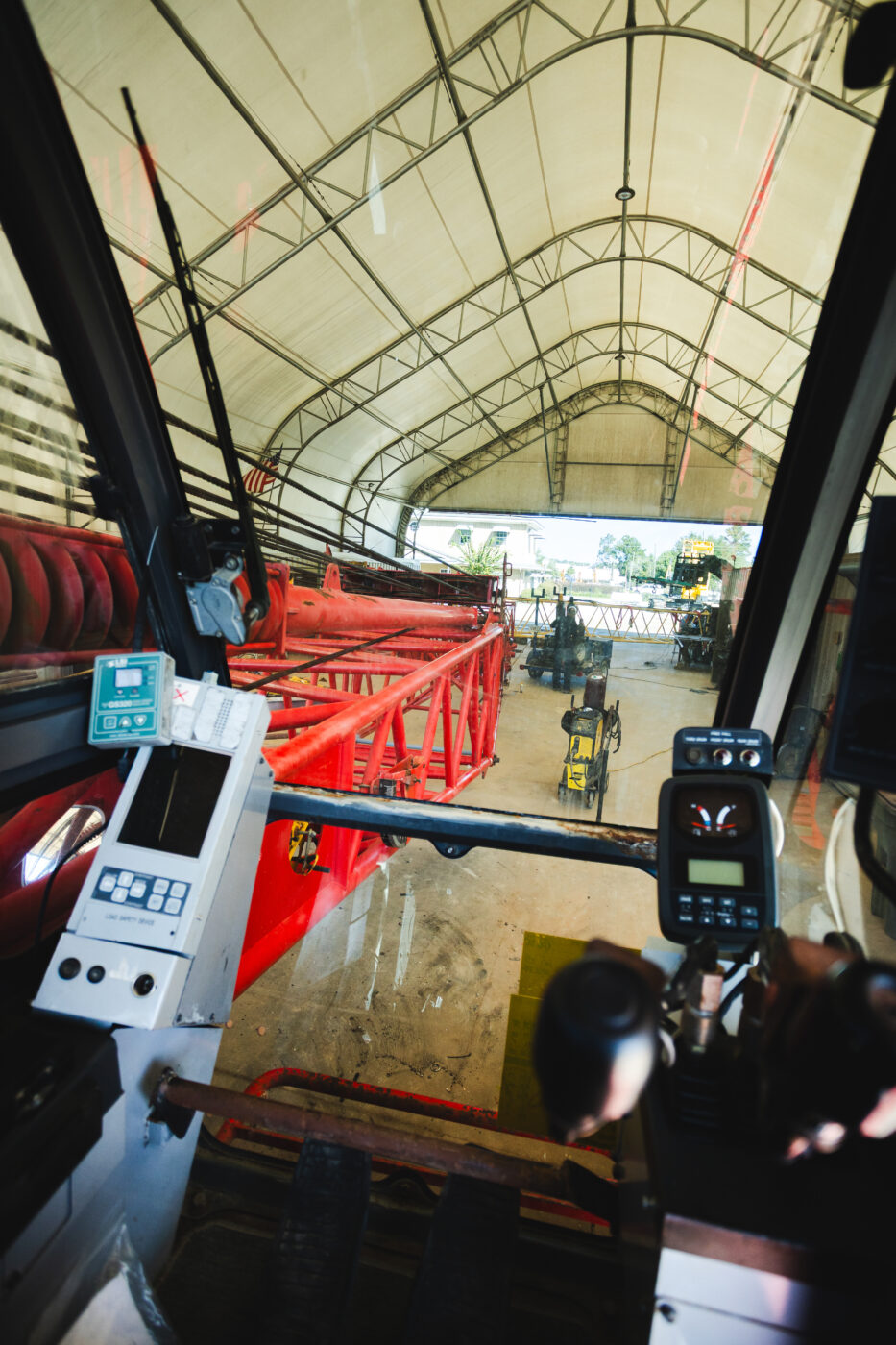 looking out from inside the controls of a crane