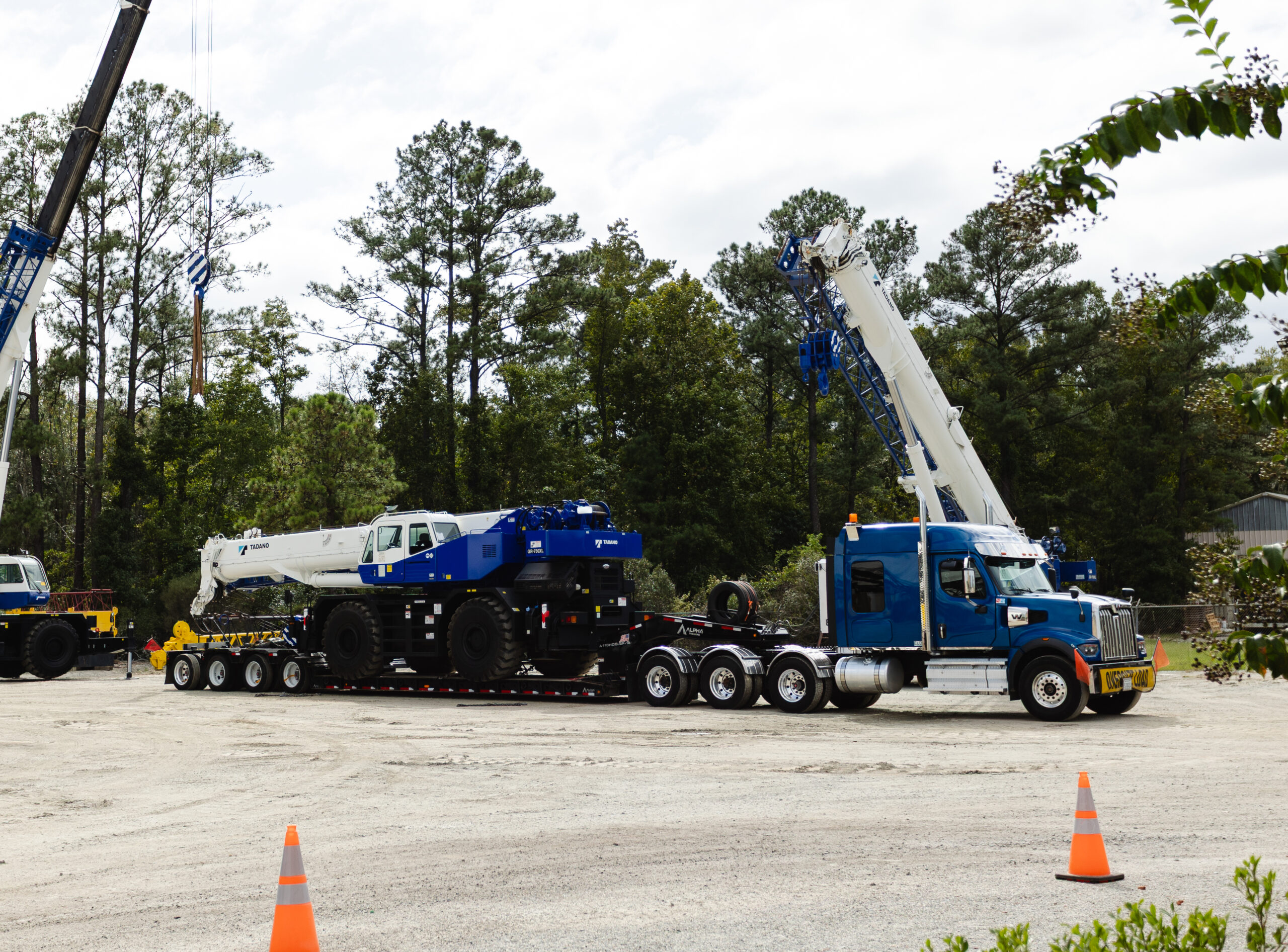 Heavy hauling and specialized logistics equipment moving a crane from a construction site
