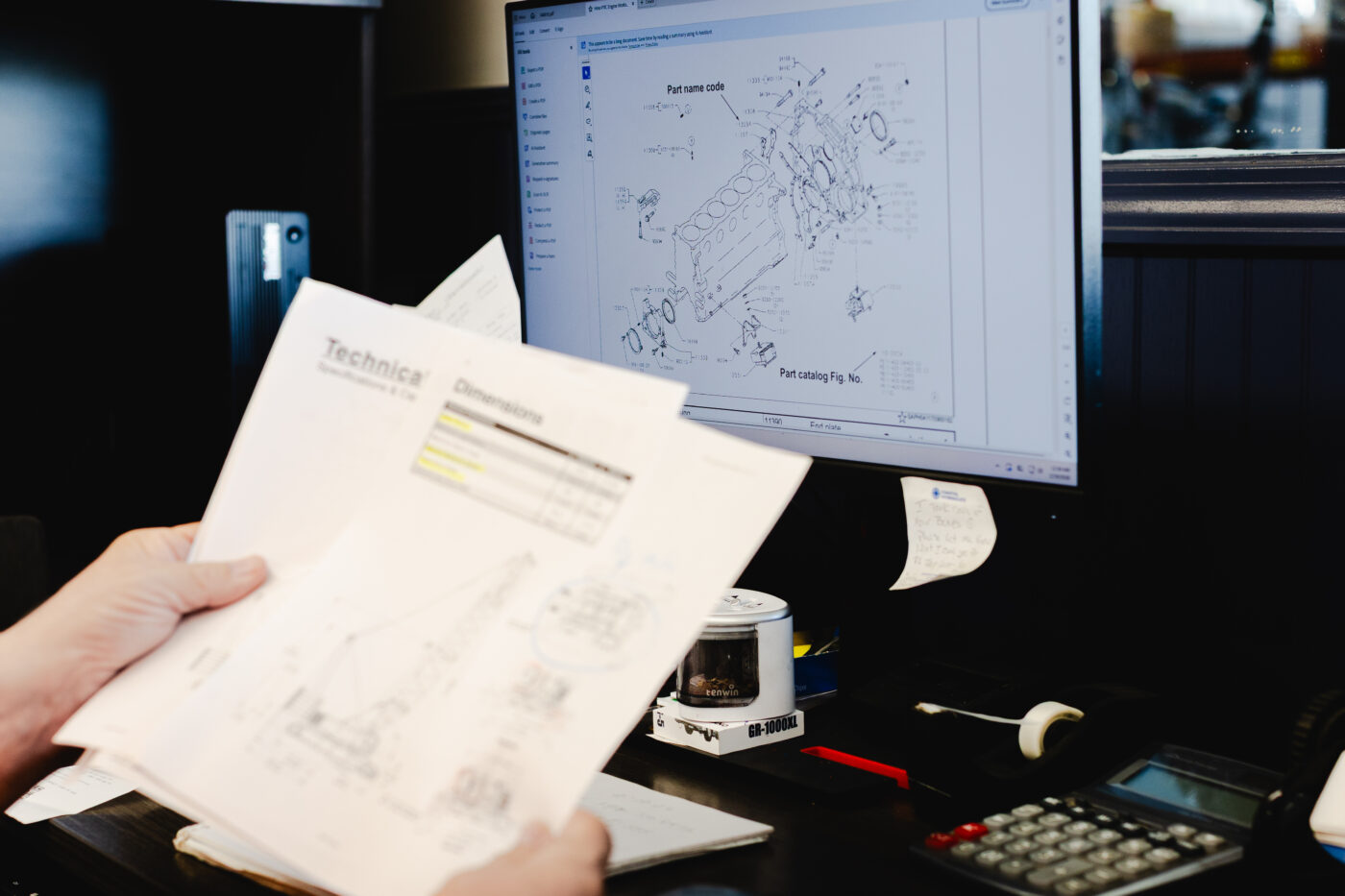 certified technician reviewing crane part documents to ensure OEM parts for crane maintenance at Dozier Crane Savanah GA